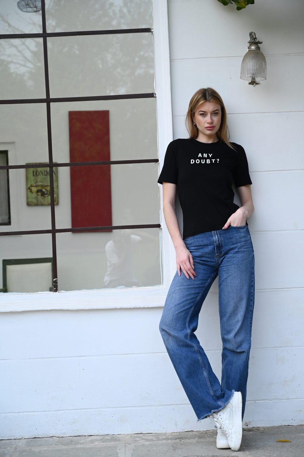 Woman wearing black cotton t-shirt with ghost sticker print – fun and casual look