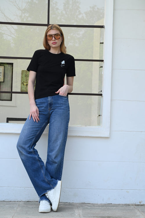 Woman wearing black cotton t-shirt with ghost sticker print – fun and casual look